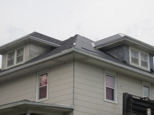 The old shingles are on the left, the new steel is on the right.
